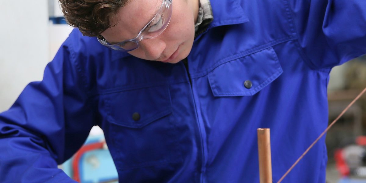 student in plumbing professional training, working on copper Schlagwort(e): metallurgy, welder, solderer, plumber, plumbing, copper, professional, craftsman, craftsmanship, young, man, apprentice, training, trainee, apprenticeship, overall, blue, protection, protective, glasses, melting, worker, working, workshop, heating, student, metallurgy, welder, solderer, plumber, plumbing, copper, professional, craftsman, craftsmanship, young, man, apprentice, training, trainee, apprenticeship, overall, blue, protection, protective, glasses, melting, worker, working, workshop, heating, student, ausbildung